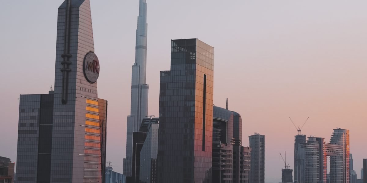 Dubai skyline seen from a modern office desk with laptop
