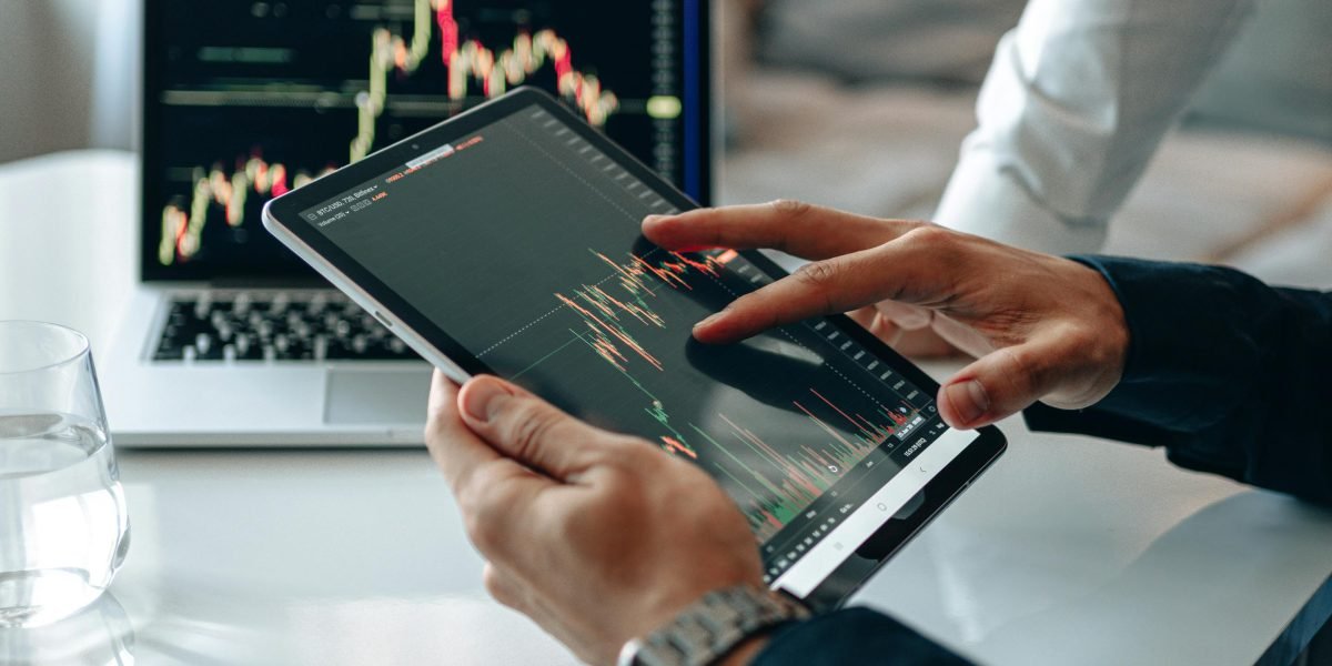 A person studying market data, representing the analysis of rental yields and sales prices.