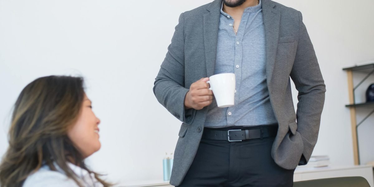 Colleagues having an informal discussion over coffee, sharing insights and market knowledge.