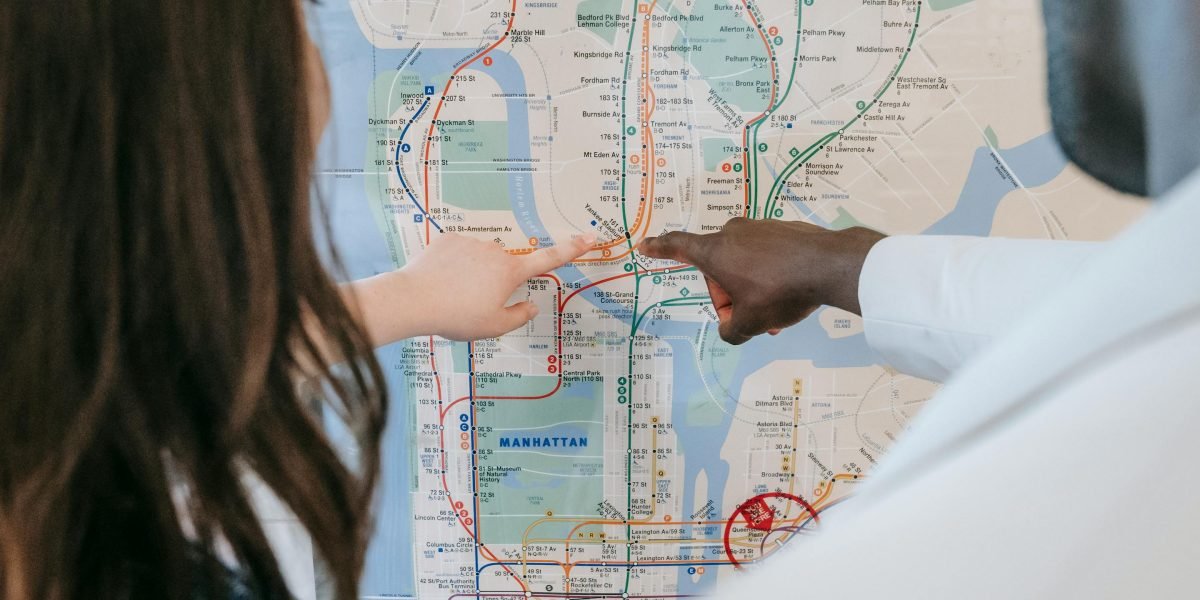 A couple discussing specific neighborhood details on a map, emphasizing the importance of hyperlocal search in Dubai's diverse market.