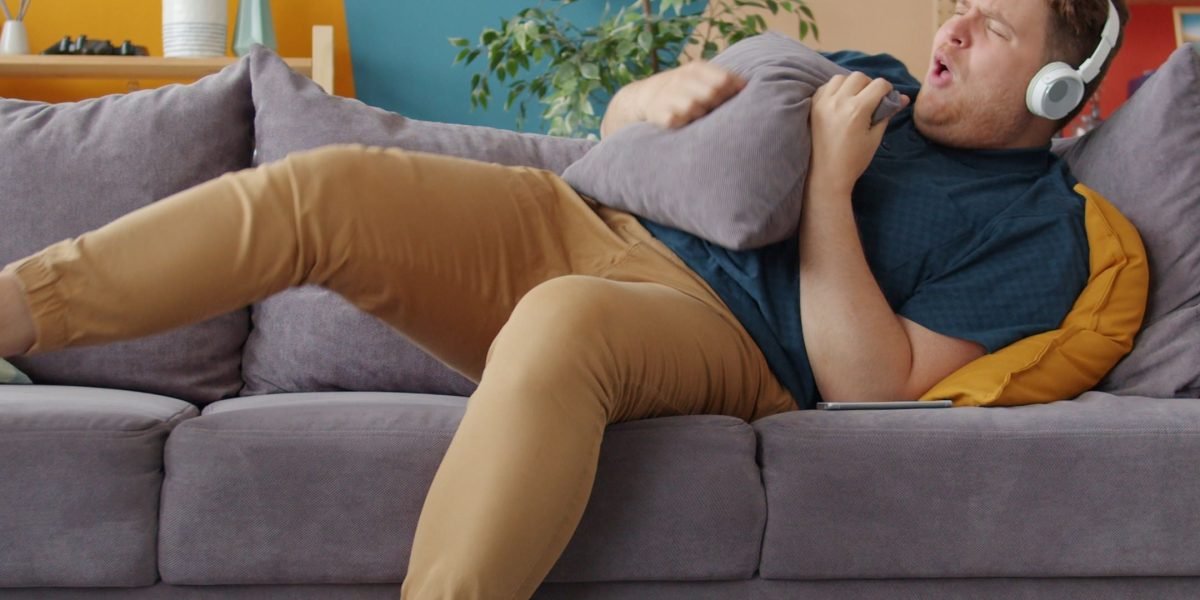 A person relaxing comfortably in a bright, modern living space, emphasizing design benefits.