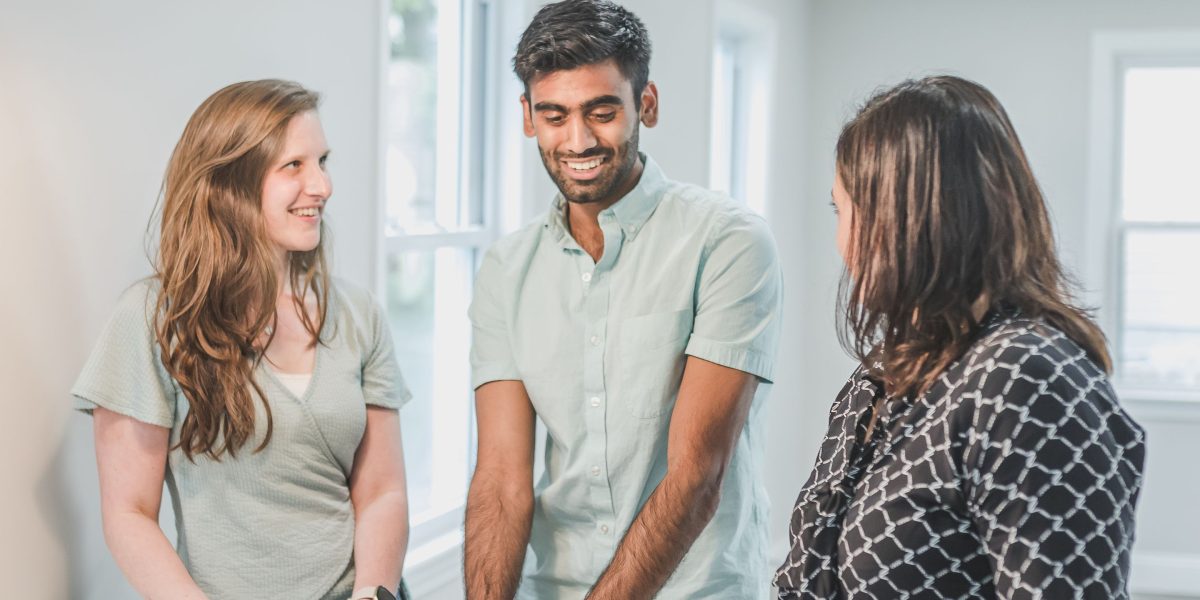 A couple thoughtfully weighing the pros and cons of renting versus buying a home in a new city.