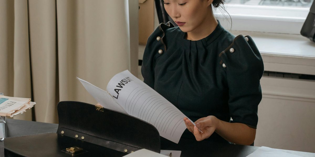 An individual carefully examining legal documents, emphasizing the importance of due diligence in property transactions.