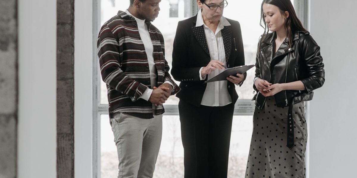 A real estate agent assisting a client through various property listings on a digital platform.