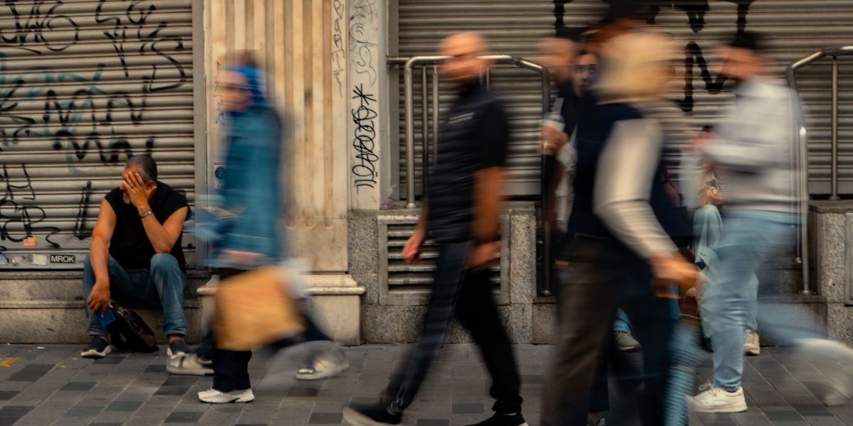 People from diverse backgrounds walking and interacting on a lively street, reflecting Al Rigga's vibrant community.